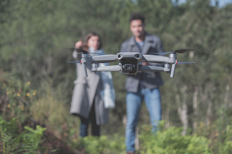 Christophe Castagné photographe vidéaste qui pilote un drone dans une forêt des Landes